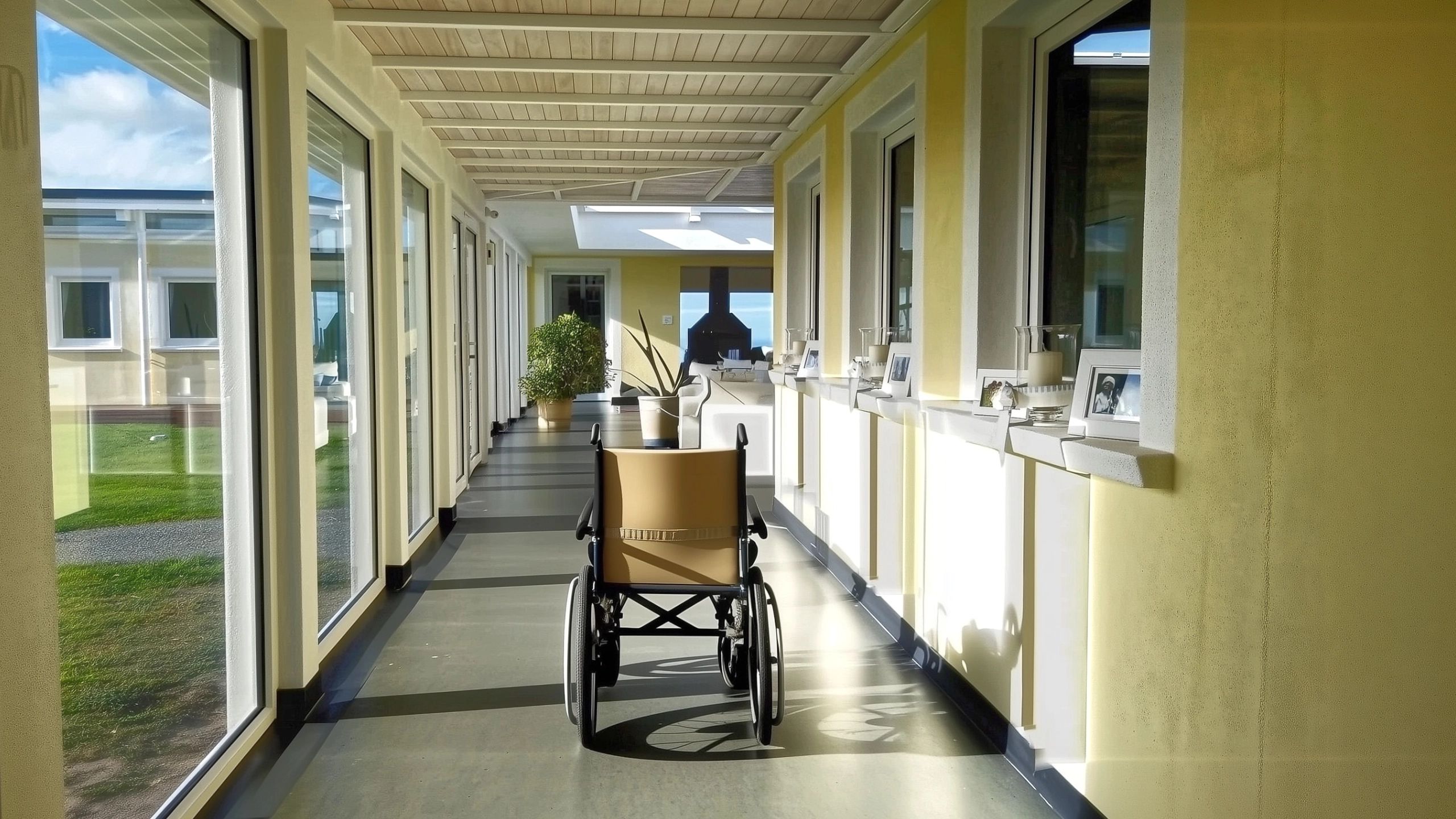 Wheelchair in wide walkway of accessible water front house demonstrating barrier free design principles.