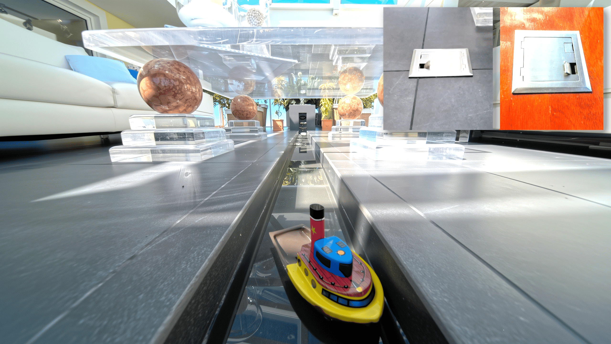 Shallow indoor water feature channel in unique home for sale Atrium with toy boat and recessed floor power outlet.
