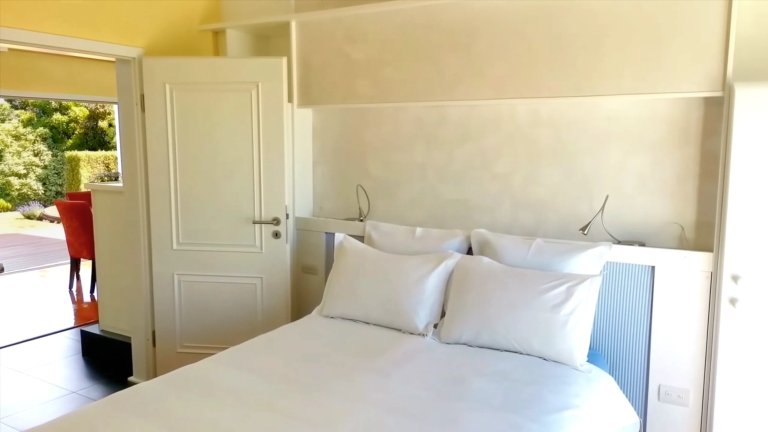 Master bedroom in guest house / inlaw suite featuring queen bed and built-in bedside cabinetry.